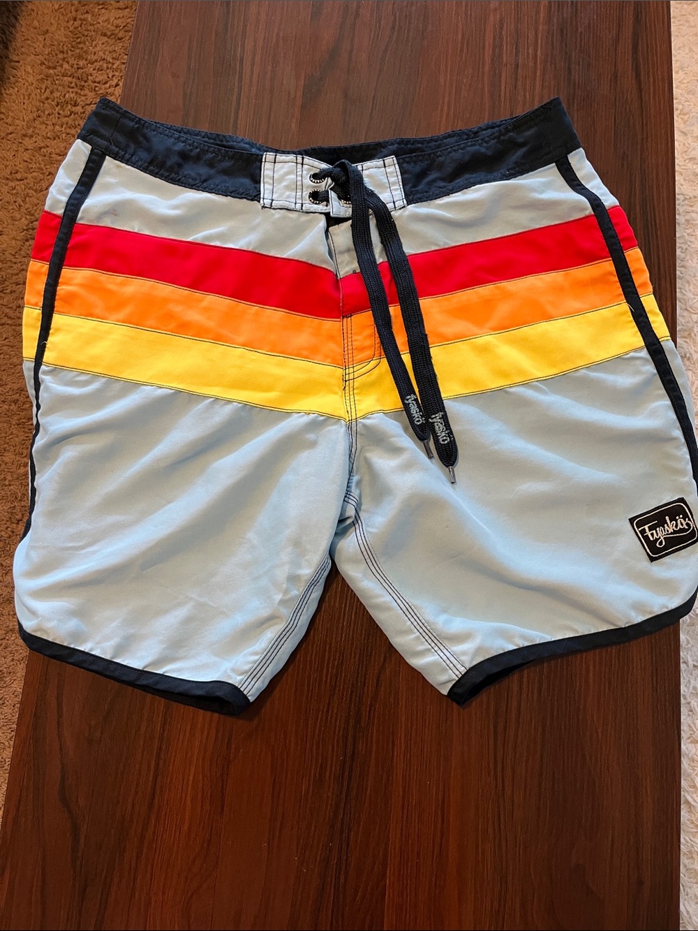 Light Blue Men’s Swim Trunks with Red, Orange & Yellow Stripes. Fyasko brand. 34